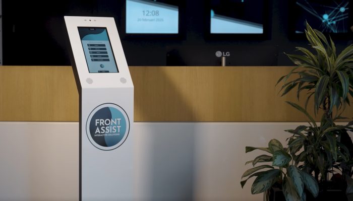 Freestanding MGtal reception kiosk next to a reception desk