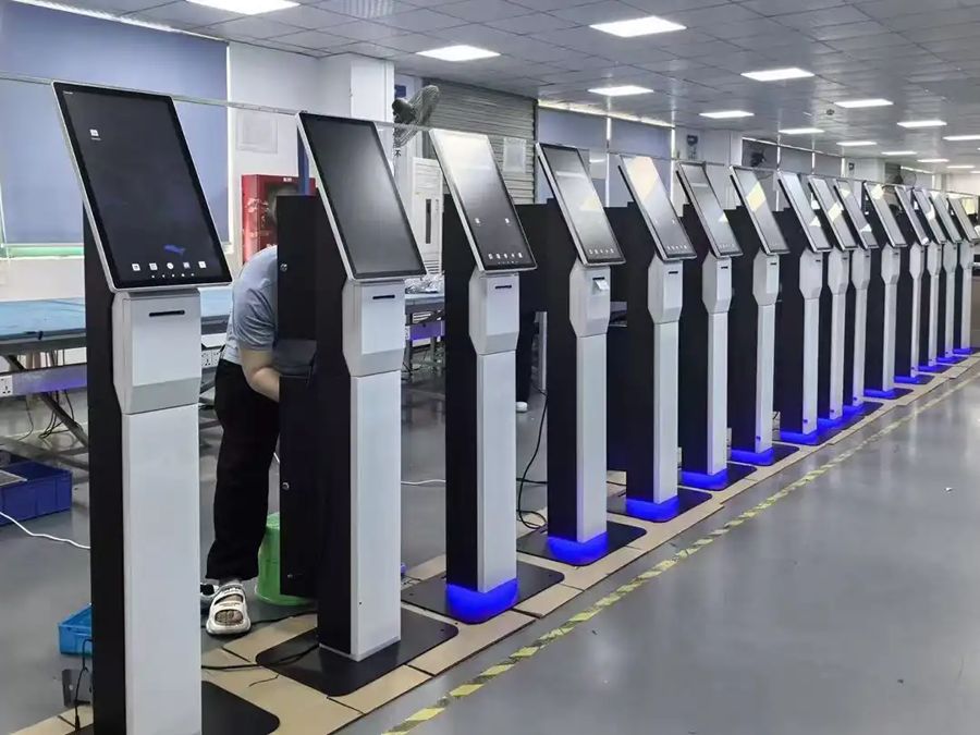 Row of finished kiosks on the production floor